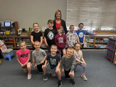 Image of a volunteer with group of students